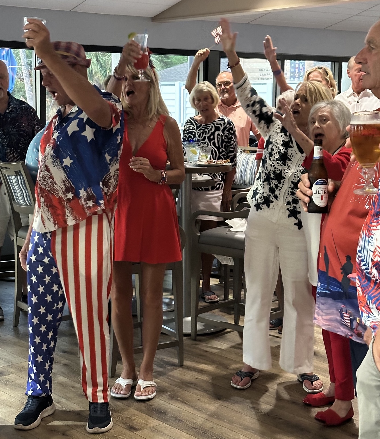 Guests in red, white and blue raising a toast at Wheelhouse Grille