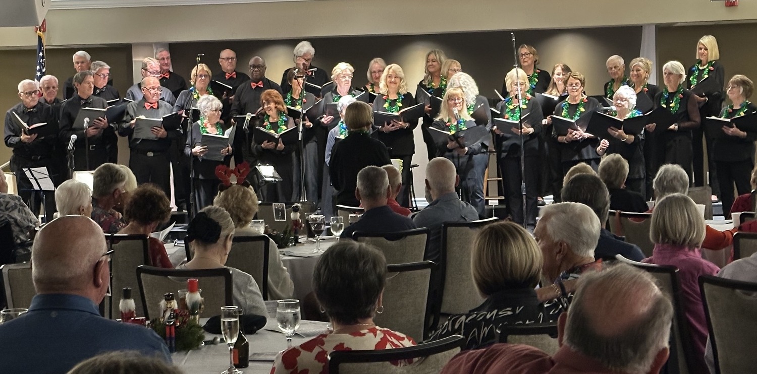Landings Chorus performing before a seated audience at the Helm Club